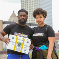 De'Von Truvel and Sinclair Founders of Play Black Wall Street holding Black Wall Street the Board Board in Tulsa